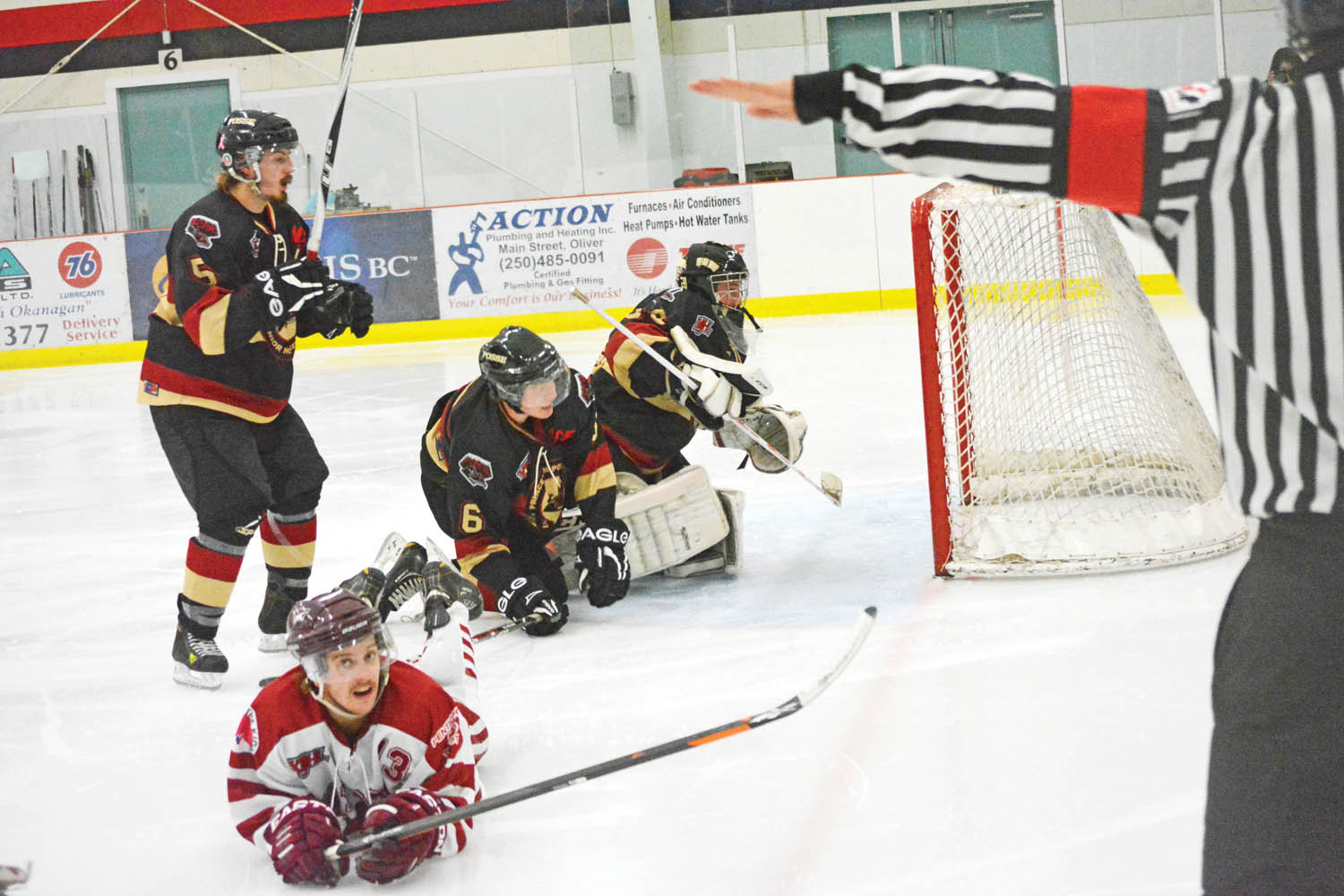 Troy Maclise of the Osoyoos Coyotes does some ice surfing after a play in front of the Princeton net in a league game at the Oliver Arena last Sunday. The Coyotes exploded in the third period to defeat the rival Posse 6-2. (Lyonel Doherty photo)