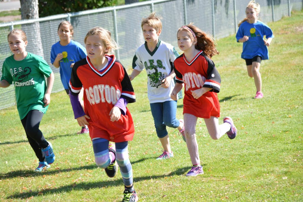 Pacing was the key in the district cross-country run at Tuc-el-Nuit Elementary School in Oliver last week. Wearing “Osoyoos,” Osoyoos Elementary students April Collier (left) and Scotlynn Purssey show fatigue during the race. (Lyonel Doherty photo)