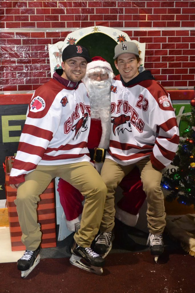 MacKenzie Wiens and Colton Rhodes of the Osoyoos Coyotes are never too old to plop down for a picture on Santa’s lap. (Trevor Nichols photo)