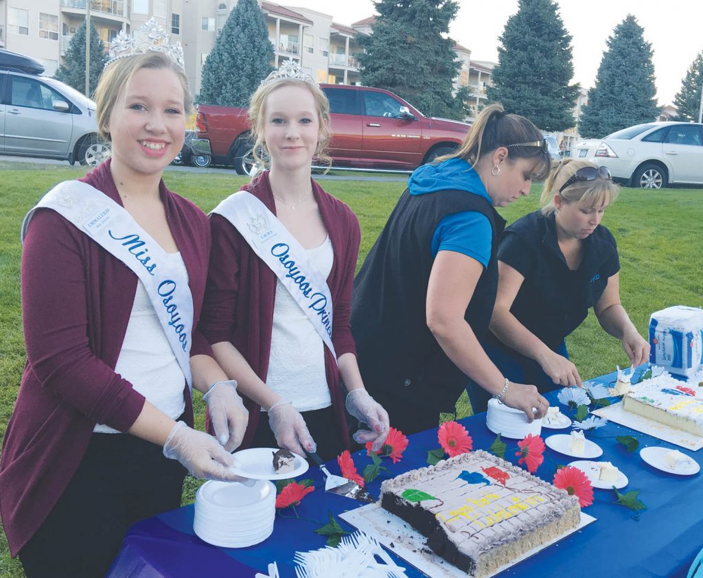 Osoyoos Royalty Miss Osoyoos Emmaleigh Diwell (left) and Princess Laura Devries helped to serve cake at the recent Gyro Park celebration in Osoyoos. (Contributed photo)
