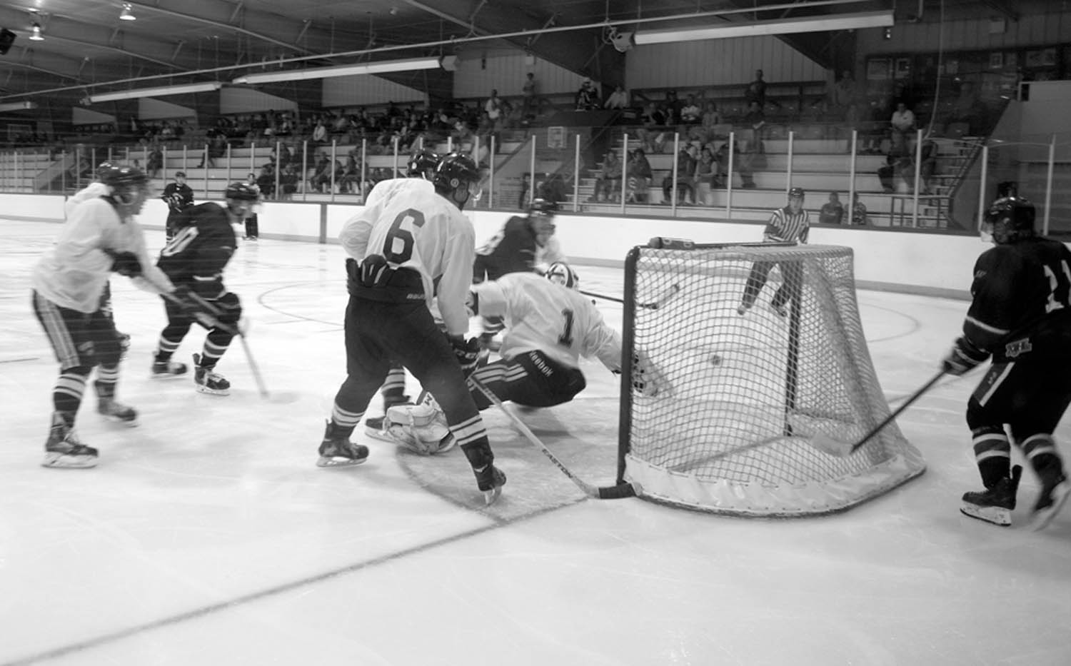 Players from the Summerland Steam pressure the Osoyoos Coyotes’ defence and goaltender during exhibition action Saturday night at the Sun Bowl Arena. The Coyotes open the 2014-15 KIJHL regular season Friday night in Armstrong. They host Chase Heat Saturday evening at the Sun Bowl Arena in their home opener. (Keith Lacey photo)