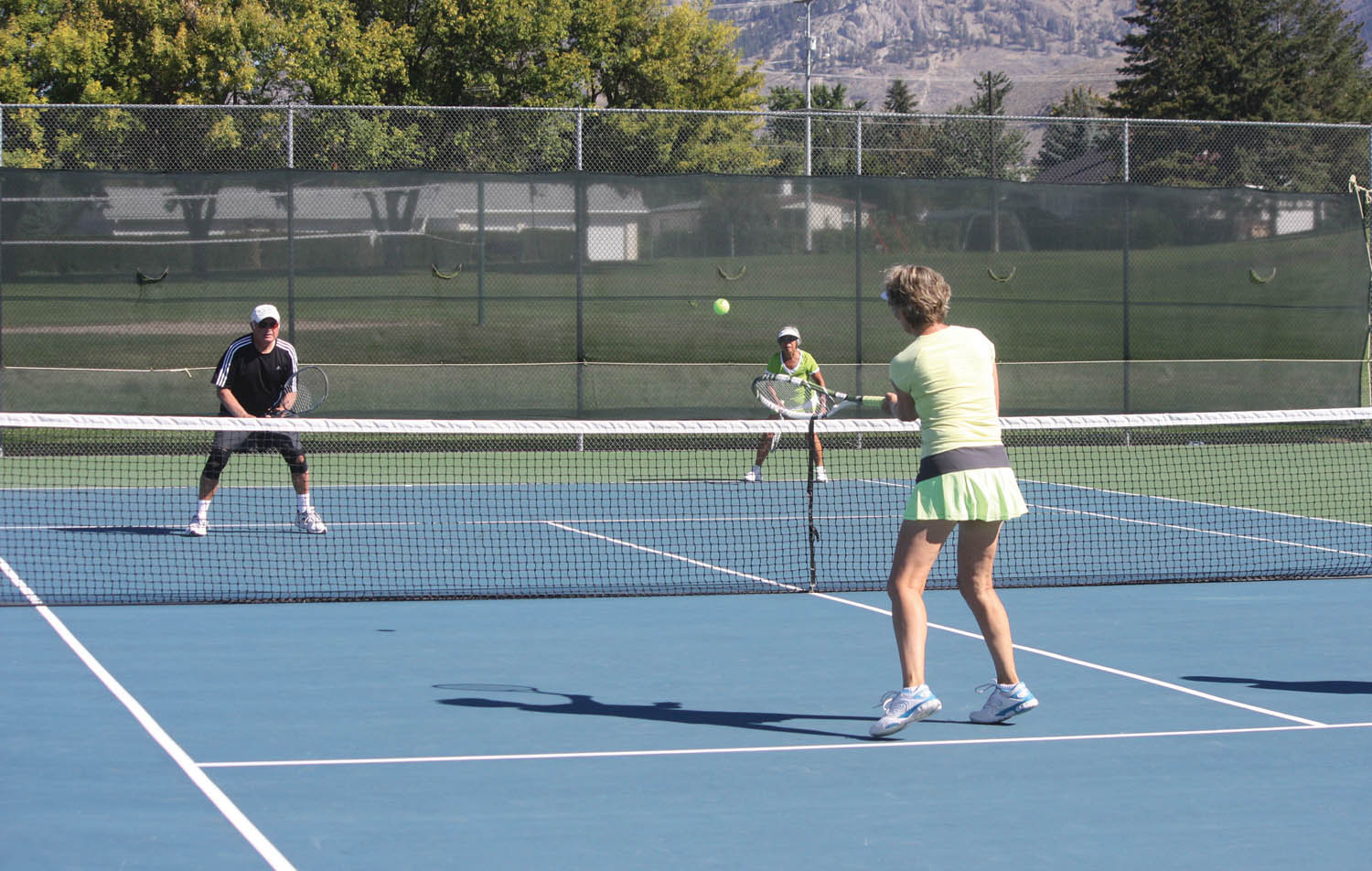 A total of 16 teams participated in the sixth annual Oliver Tennis Club Mixed Doubles tournament this past Saturday. Tennis players from Osoyoos, Oliver, Okanagan Falls, Penticton and Kelowna participated in the popular event. Above, Janet Shaw hits a nice shot towards her opponents during early round-robin action. (Keith Lacey photo)