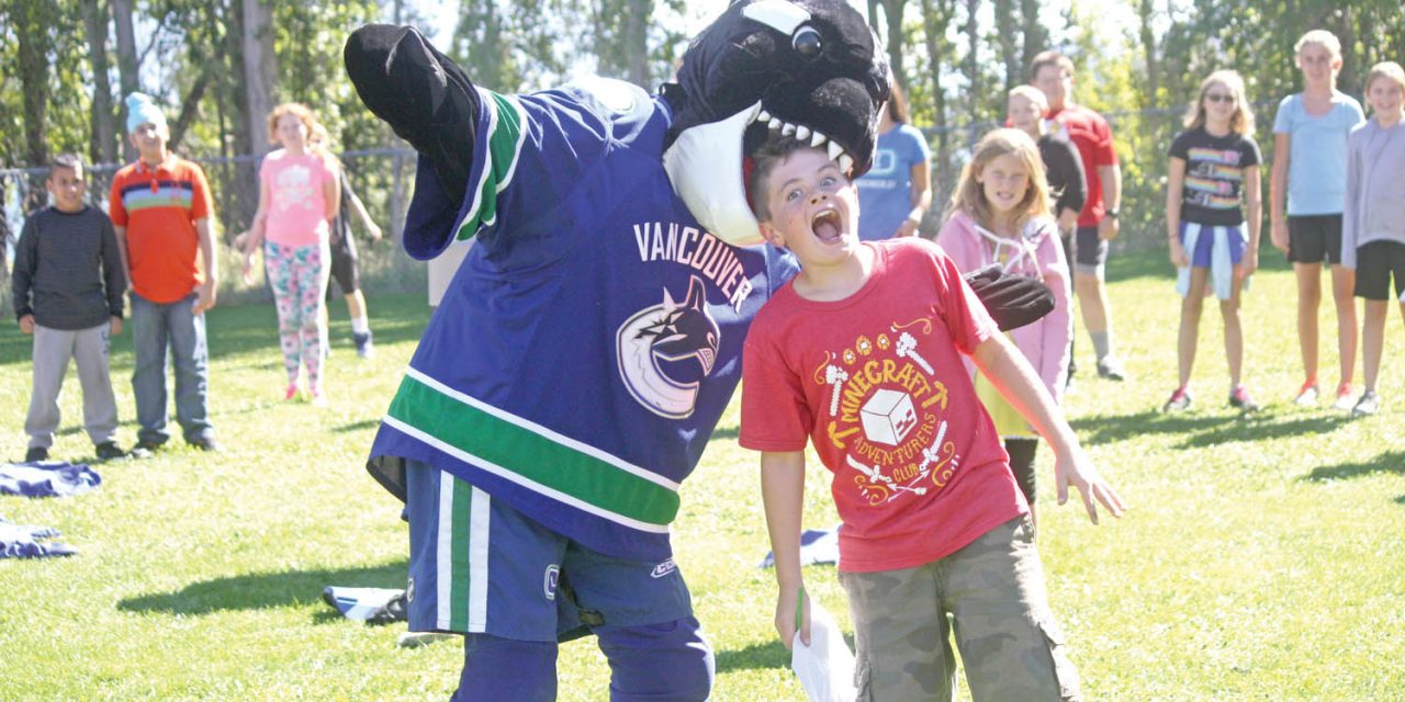Canucks mascot Fin comes bearing gifts during visit to Osoyoos Elementary School