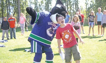 Canucks mascot Fin comes bearing gifts during visit to Osoyoos Elementary School