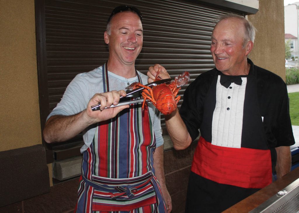 The Osoyoos Rotary Club’s third annual Lobster on the Beach fundraiser was again a huge success this past Saturday as the event was completely sold out with more than 250 in attendance. Local Rotarians Trevor Leigh (left) and Harold Cox helped serve the lobsters. (Keith Lacey photo)