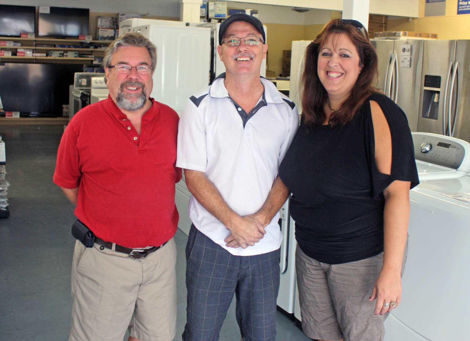 Spencer and Theresa Toepfer were all smiles in the summer of 2013 when they signed a deal to take over the operations of the Sears retail outlet in Osoyoos. The Toepfer’s claim two-and-a-half years of hard work has been for naught as Sears’ head office in Ontario has informed them the Osoyoos store will close for good on May 9. The Toepfers are seen with former employee Randy Kassian days after taking over the retail outlet. All current merchandise is on sale until the store closes. (Keith Lacey file photo)