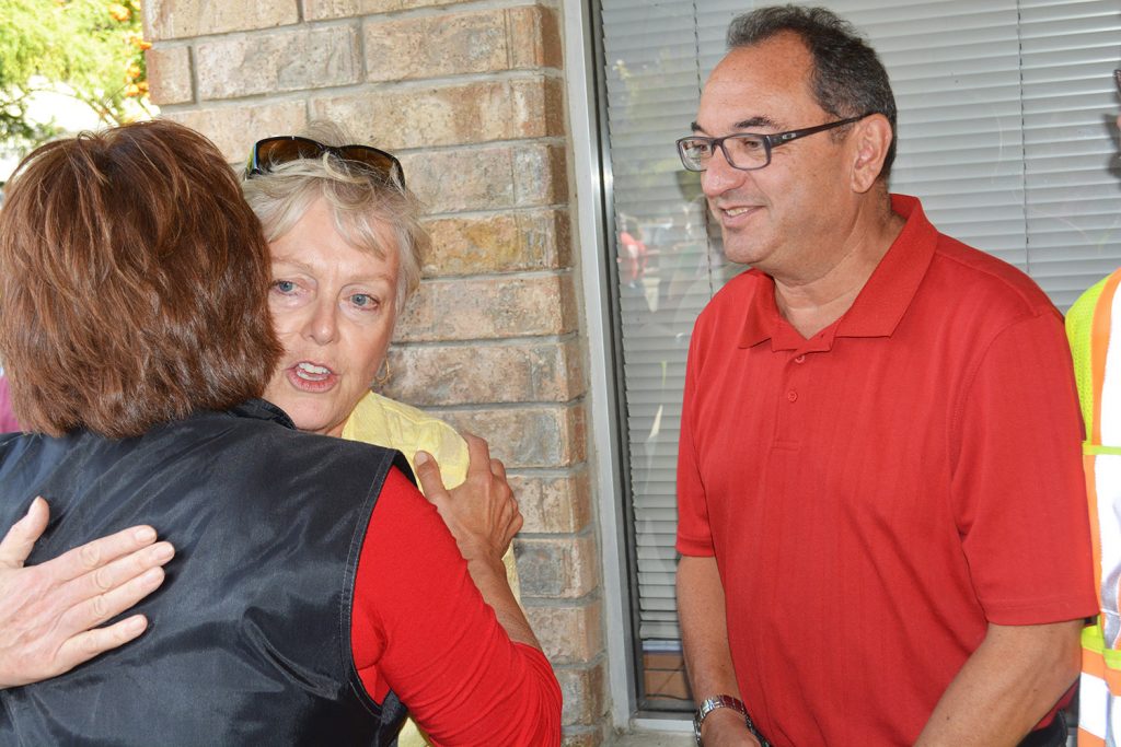 Premier Christy Clark hugs Osoyoos Mayor Sue McKortoff, while Oliver Mayor Ron Hovanes looks on. Clark made a quick visit to Oliver to personally thank firefighters and volunteers. (Lyonel Doherty photo)