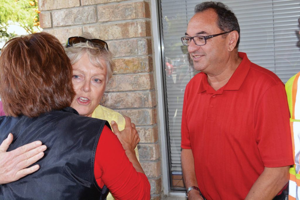 B.C. Premier Christy Clark flew into Oliver Sunday morning to view the devastation caused by wildfires in and around Oliver and Osoyoos. Clark thanked firefighters and volunteers for a job well done and also got a big hug from Osoyoos Mayor Sue McKortoff, while Oliver Mayor Ron Hovanes looked on. (Lyonel Doherty photo)