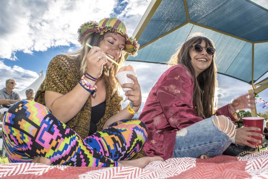 Laura Penney (left) and Sara Titus enjoy cool treats while taking in the music at the Oliver Sunshine Festival last weekend. After rain threatened to put a damper on last Saturday’s parade, the sun came out and so did hundreds of people. (Dan Walton photo)