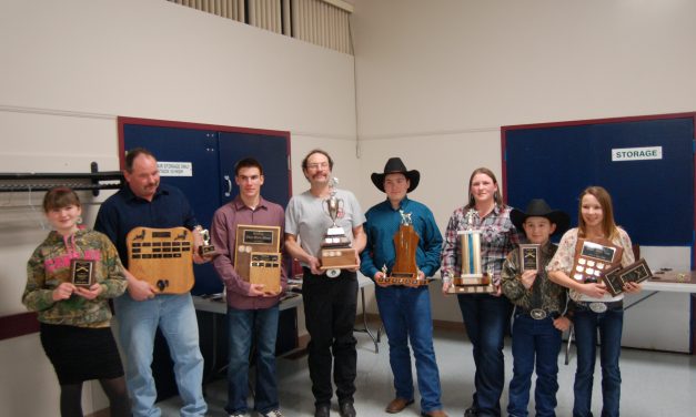 Sportsmen and ladies bag trophies at dinner