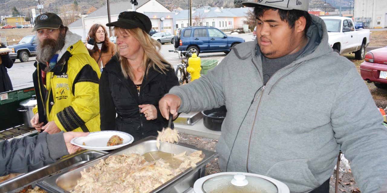 Food bank volunteers serve turkey breakfast