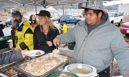 Food bank volunteers serve turkey breakfast