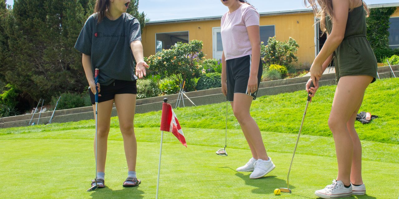 Young women take a swing at golf