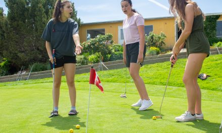 Young women take a swing at golf