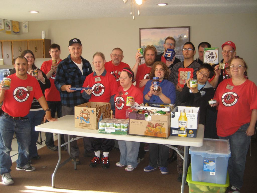 Members of the Aktion Club of Osoyoos and Oliver recently delivered more than 100 food items to the Osoyoos Food Bank. The service club for adults with disabilities operates under the Kiwanis Club’s umbrella. Because the Kiwanis Club is celebrating its 100th anniversary, the Aktion Club donated 100 items to food banks in both Osoyoos and Oliver. Food bank volunteer Brian Zorn is pictured receiving the items. (Photo supplied)