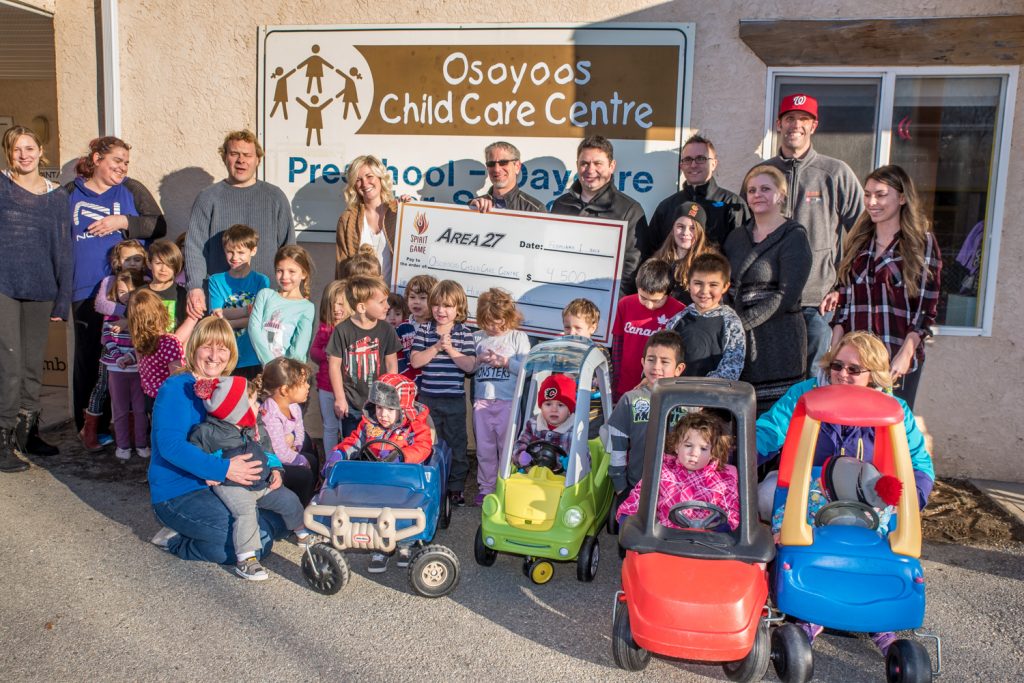 Area 27 made a $4,500 donation last week through Spirit of the Game Society for a new playground surface at Osoyoos Child Care Centre. The surface will allow playground equipment donated last year by Osoyoos Credit Union to be installed. Some of the youngsters may have been getting a head start on car racing careers. (Richard McGuire photo)
