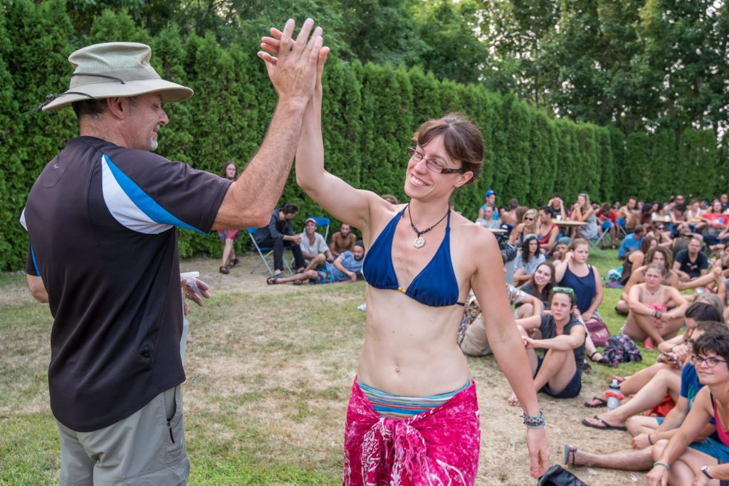 Stephanie Dupont, from Montreal, high fives Senior Pastor Terry Kaethler from Mountain Park Community Church in Abbotsford as she goes up for dinner. (Richard McGuire photo)