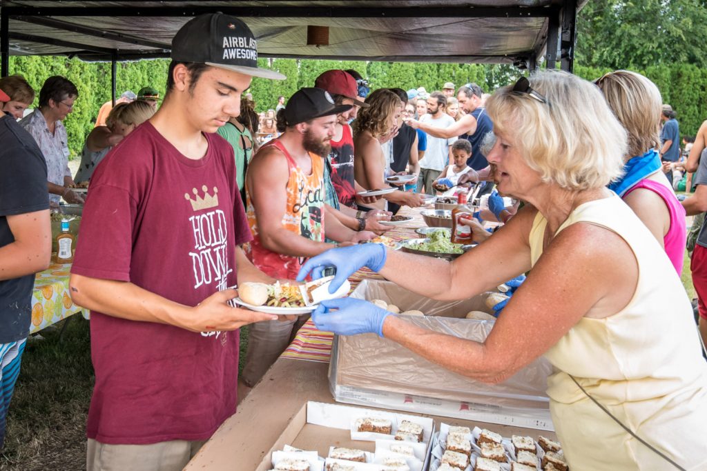 Church volunteer Ingrid Katzberg, of Osoyoos, helps Vincent Girard, of Roberval, Quebec fill up his plate. (Richard McGuire photo)