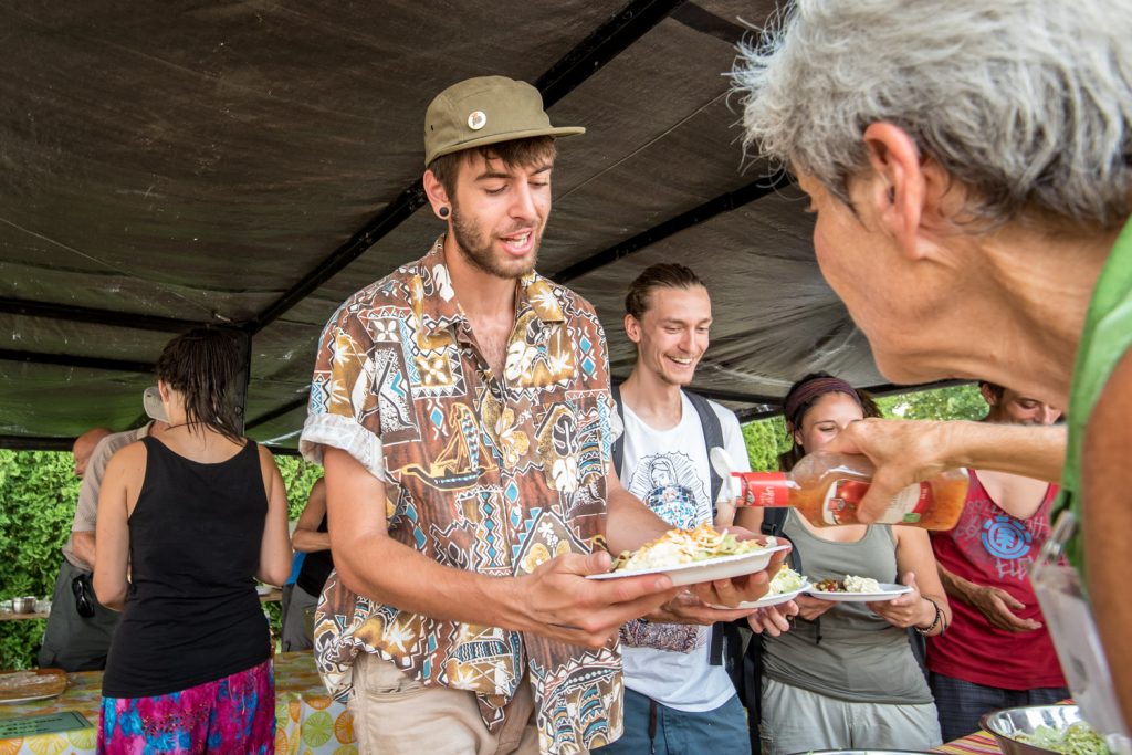 Church volunteer Ruth Glover (right) pours salad dressing for Philippe Huot, of St-Basile-le-Grand, near Montreal. (Richard McGuire photo)