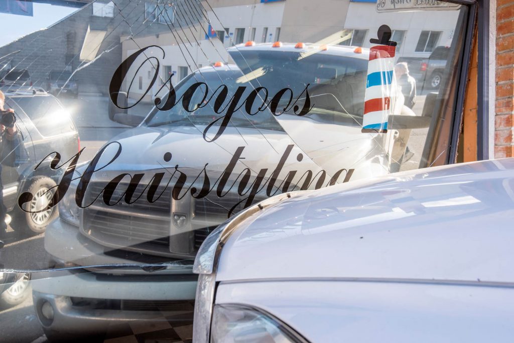 Osoyoos Hairstyling has not yet started offering drive-in service. The shop’s large storefront window was smashed around lunchtime Tuesday when a woman accidentally drove a Ram pickup truck onto the sidewalk and into the window. When the Osoyoos Times showed up, the RCMP had not yet investigated and a cause had not yet been determined. (Richard McGuire photo)