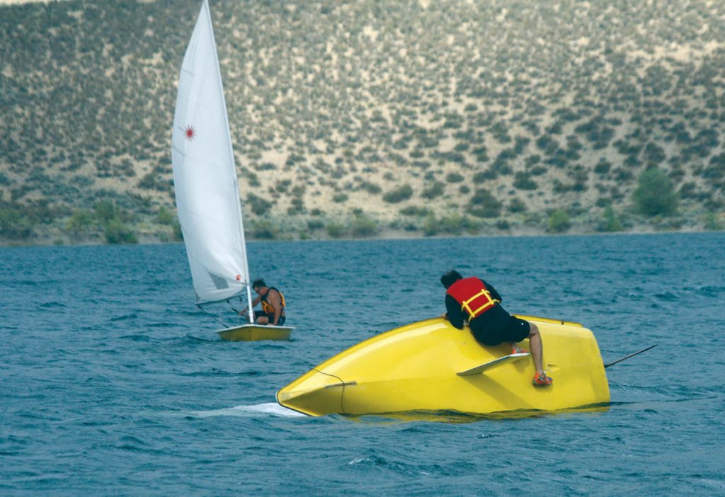 A member of the Osoyoos Sailing Club fights to keep control as high winds tipped over his craft this past Sunday afternoon on Osoyoos Lake. Local sailors were participating in Bart’s Bash, which has been recognized by the Guinness World Book of Records as the world’s largest mass participation sailing event. (Trevor Nichols photo)