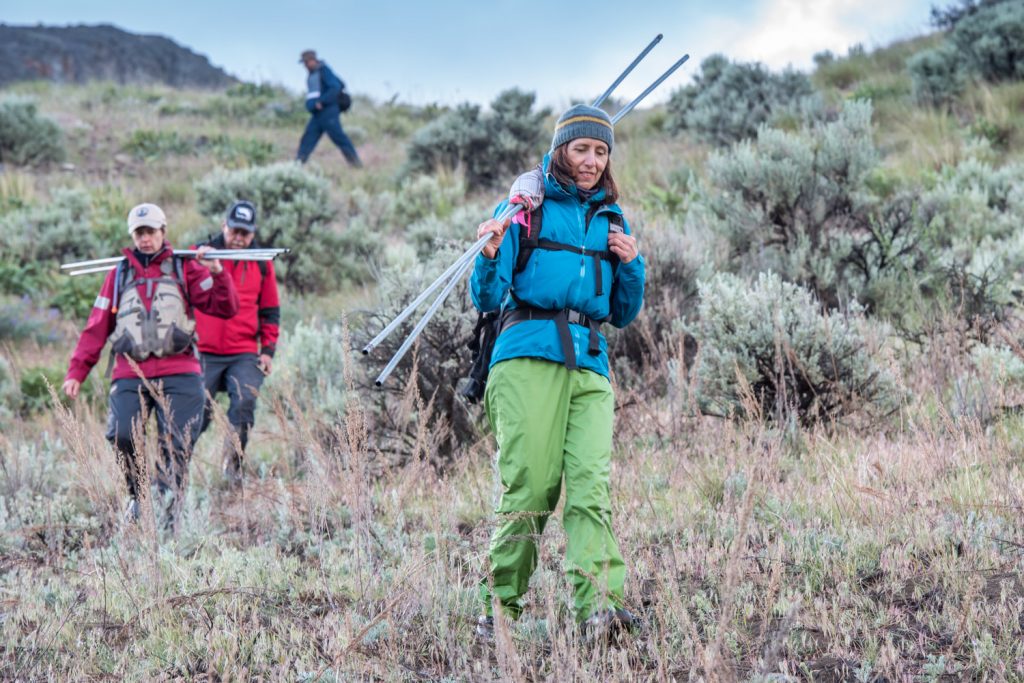 Tanya Luszcz carries down poles and other gear followed by René McKibbin and Doug Burles. (Richard McGuire photo)