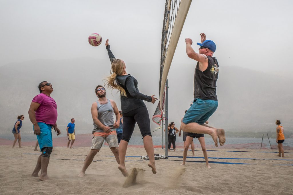 Amy Bartsch (centre) jumps to try to hit a ball knocked over the net by Ryan Pyatt (right) while Jessie Toor (left) and Jeremy Knechtel watch the action, ready to move in. Bartsch and her Desert Hills All Stars were playing against Sand N Macrack in one of the final games of the Osoyoos Beach Volleyball league. (Richard McGuire photo)