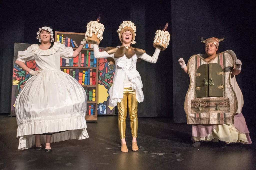 Actors perform a scene from Osoyoos Secondary School drama club's production of Beauty and the Beast. From left are Tianna Morgan as Mrs. Potts, Emma Fernandes as Lumiere and Flor Guevara as Madame de la Grande Bouche. The musical will be staged this Friday, Saturday and Sunday. (Richard McGuire photo)