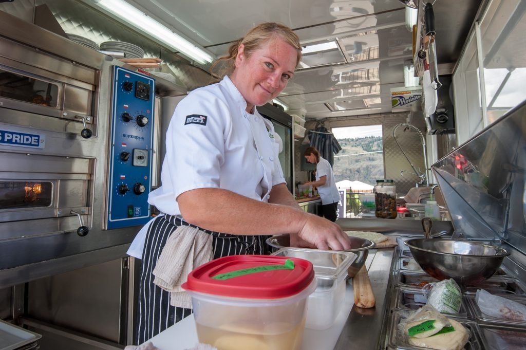 Sam Laven prepares food at Joy Road Vineyard Kitchen at Black Hills Estate Winery. The kitchen is built into a re-purposed shipping container. (Richard McGuire photo)