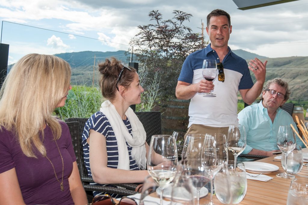 Winemaker Graham Pierce (standing) discusses a red wine with guests at a tasting experience held at Black Hills Estate Winery. (Richard McGuire photo)