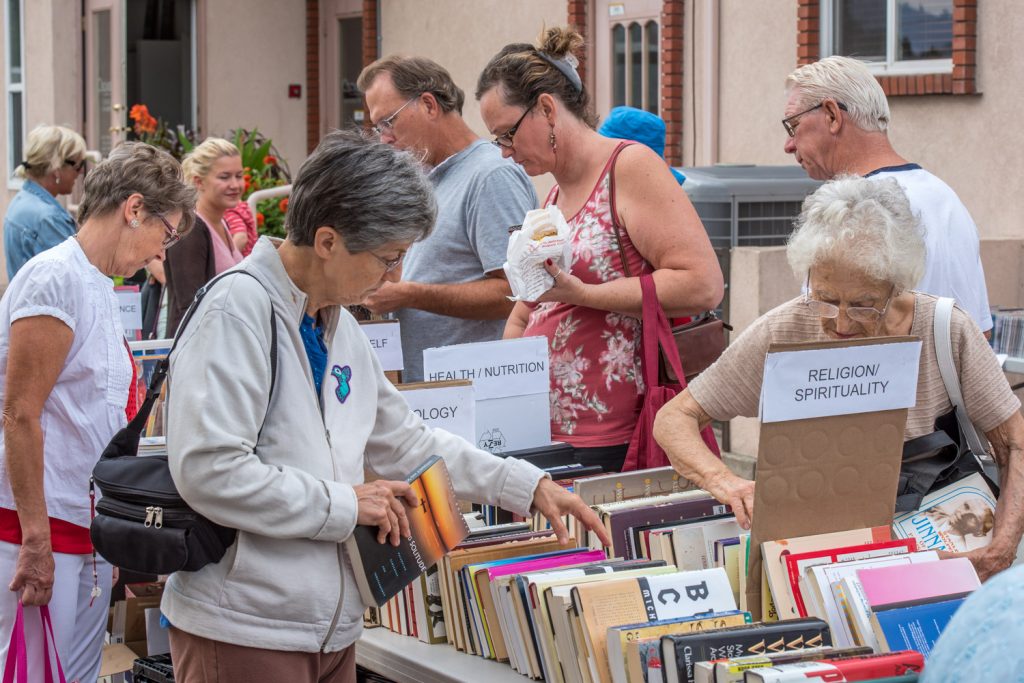 Bookworms look for bargains at the Friends of the Library’s annual book sale in front of the Town Hall on Saturday morning. The Friends of the Library is a volunteer group that raises money through the book sale to help the library with special purchases and speakers’ honorariums. (Richard McGuire photo)