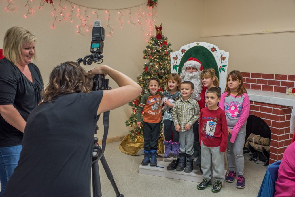 Osoyoos Coyotes Colton Rhodes (left) and Carter Shannon serve breakfast to Brody Knight, 8, of Osoyoos Saturday morning at Breakfast with Santa and Photos at the Osoyoos Baptist Church. The event was sponsored by Osoyoos Child Care Centre. (Richard McGuire photo)
