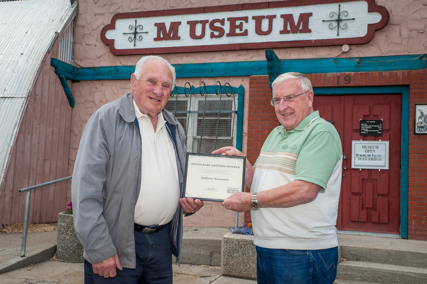 Mat Hassen (right), president of the Osoyoos Museum Society, presents a certificate to Tony Brummet recognizing him as an honorary lifetime member. Brummet, who is currently a director, has served in other capacities on the museum board since joining it more than a decade ago. (Richard McGuire photo)