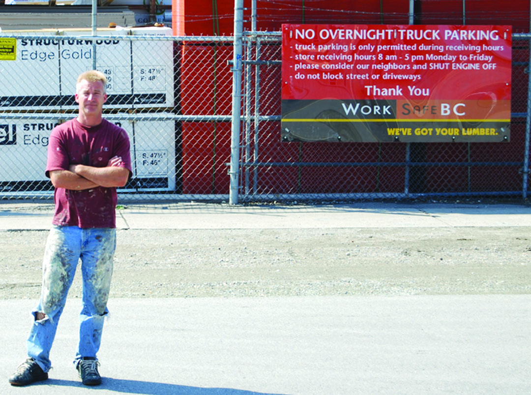 buildingcentrefeudweb1 Victor Wright stands on the zoning border that divides “downtown commercial” from “single family residential” down the middle of 78th Avenue. His home’s location makes him neighbours with the Osoyoos Home Building Centre and he said living next door to the centre has been causing him to lose sleep. Photo by Laurena Weninger