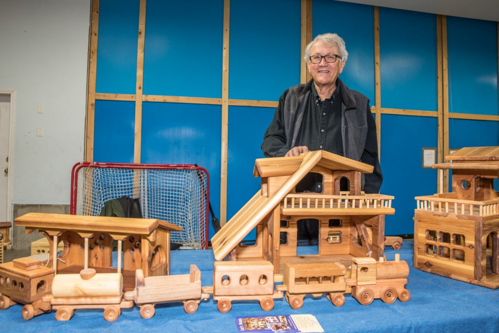 Lee Whitehead, of Kilpoola near Osoyoos, displays his magnificent wooden doll houses at the craft fair on Saturday hosted by the 232 Bighorn Squadron Air Cadets in Oliver. Whitehead makes the houses by hand in his workshop. (Richard McGuire photo)