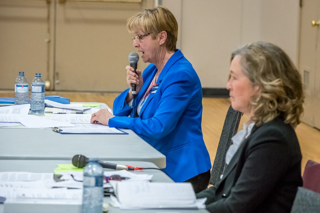 B.C. Liberal candidate Linda Larson (left), the incumbent MLA, reads from talking points while NDP candidate Colleen Ross listens and waits for her turn to speak. (Richard McGuire photo)