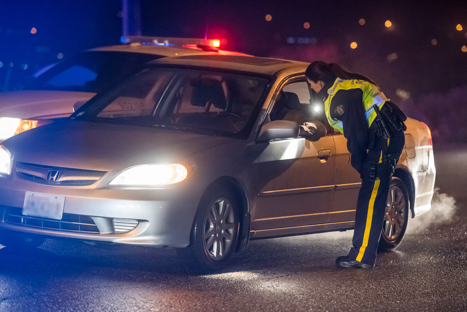 Constable Jody Rausch speaks to a driver during a CounterAttack road check on Hwy. 3 on Saturday evening. Osoyoos RCMP were on the lookout for impaired drivers, but they didn't encounter any. (Richard McGuire photo)