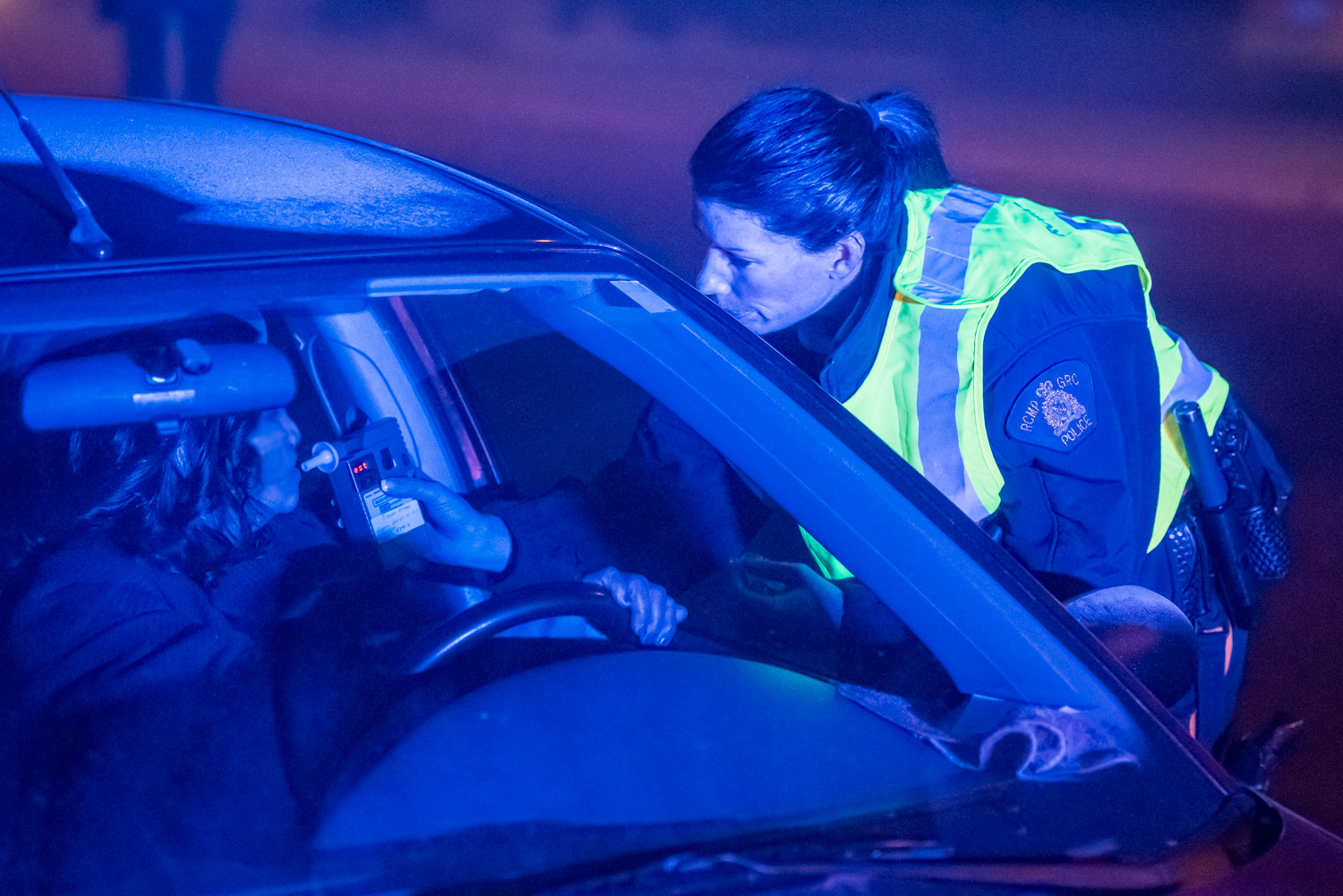 Constable Jody Rausch administers a roadside alcohol screening test to a driver after she notice the smell of alcohol in the vehicle. The driver had a reading of zero indicating she hadn't consumed any alcohol recently. Her husband in the passenger seat had consumed a few drinks and that's why he wasn't driving. (Richard McGuire photo)
