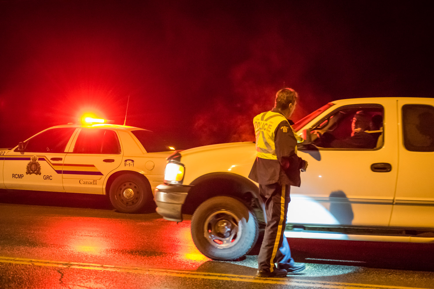 Constable Bruce Stangl speaks to a driver during a CounterAttack road check on Hwy. 3 on Saturday evening. Osoyoos RCMP were on the lookout for impaired drivers, but they didn't encounter any. (Richard McGuire photo)
