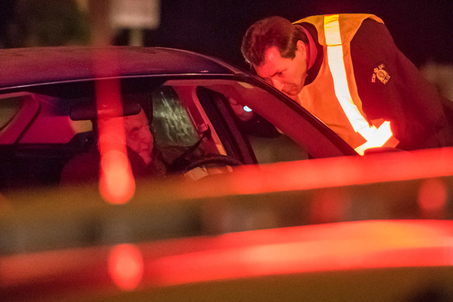 Constable Bruce Stangl speaks to a driver during a CounterAttack road check on Hwy. 3 on Saturday evening. Osoyoos RCMP were on the lookout for impaired drivers, but they didn't encounter any. (Richard McGuire photo)