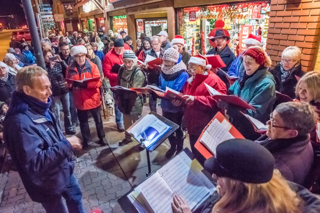 Lloyd Fairweather (left) leads the Okanagan International Chorus in Christmas carols outside Osoyoos Home Hardware on Friday just before the start of the Santa Claus parade. (Richard McGuire photo)