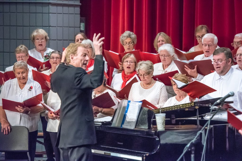The Okanagan International Chorus gave a concert of Christmas songs at the Osoyoos Community Theatre on Friday evening. Lloyd Fairweather is pictured conducting the group, whose members come from both sides of the border. The free concert, said Fairweather, was a way to thank the community. The theatre was packed full and some people were turned away. The choir performed the following night in Oroville, WA. (Richard McGuire photo)