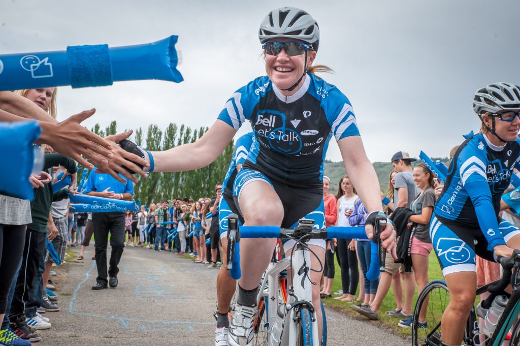 Students at Osoyoos Secondary School lined the walkway to give Clara Hughes (left) a send off as she left the school to climb Anarchist Mountain. The winner of six Olympic medals in cycling and speed skating is cycling across much of Canada to raise awareness about mental illness to try to end the stigma. (Richard McGuire photo)