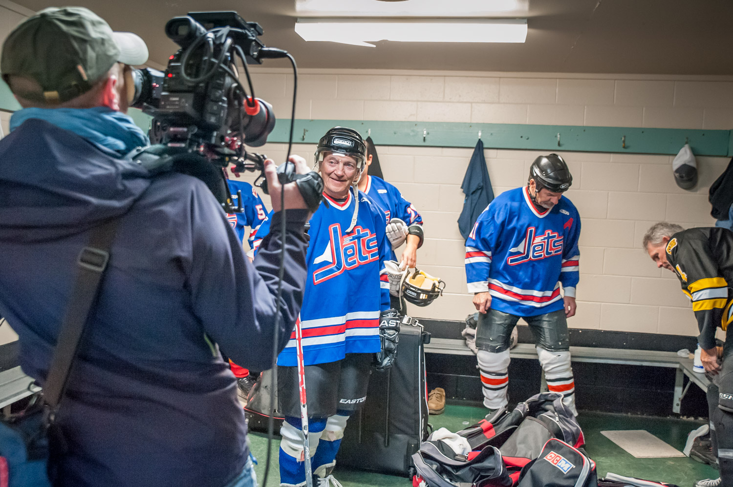 A camera man videos Harold Cox as he finishes up in the dressing room. (Richard McGuire photo)