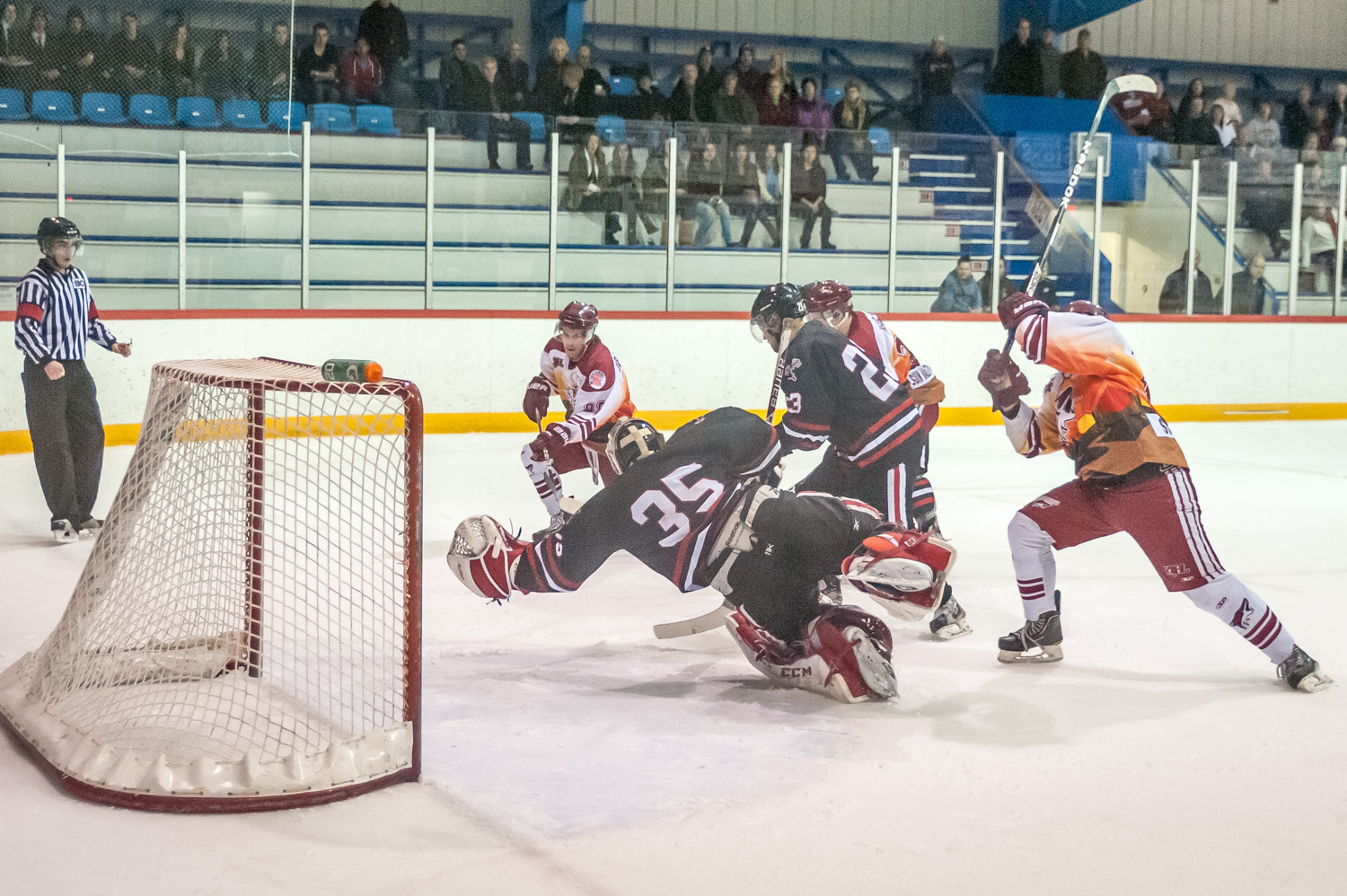 Kelowna goalie Tyler O'Donnell leaps to catch a flying puck in Saturday's game fired by Michael Crawford (left). The save didn't matter a lot -- by then Kelowna was already down 4-1 and the game was almost over. (Richard McGuire photo)