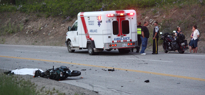crashweb A head-on collision between a motorcycle, bottom-left, and a minivan, obscured behind the ambulance, on Hwy. 3 east of Osoyoos on July 8 left the driver of the motorcycle dead. Photo by Paul Everest - Click on picture for large image