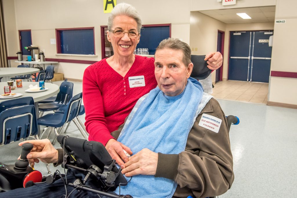 Clif Antypowich (right) founded the B.C. Crokinole Championships in Oliver seven years ago. He's shown here with his wife Joyce. Confined to a wheelchair and unable to speak, Antypowich can't play his beloved game anymore, but was at Saturday's championship at the Oliver Community Centre to watch the action. (Richard McGuire photo)