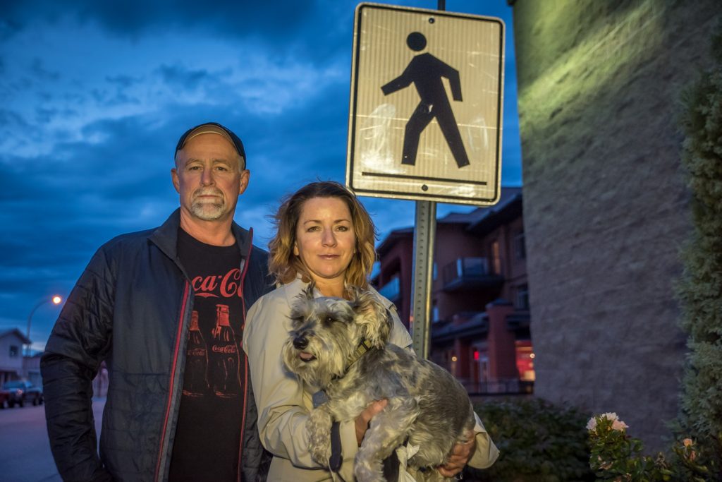 soyoos barber Sue Gerrard says she and her dog, Sophie Eloise, were nearly run down at a Main Street crosswalk when a driver failed to stop, even though she was more than half way across the street. Her boyfriend, Gary Bloomfield, pulled her back in the nick of time. She says the crosswalk is poorly lit and it occurred at dusk, but she wants to see traffic improvements. They were lit for this photo, but there is very poor street lighting on this crosswalk. (Richard McGuire photo)