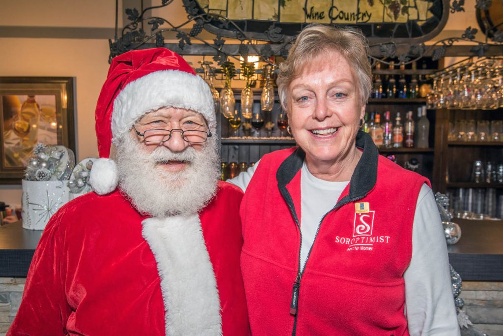 Mayor Sue McKortoff posed for a photo with Santa Claus, Mike de Salaberry, when he made his appearance at Smitty's Toys for Tots to Teens during Christmas Lite-Up in early December. McKortoff was there as a member of Osoyoos Soroptimists, one of the groups helping out at the event, which gathers toys and cash donations for the Kiwanis Club's "Share the Christmas Spirit" program. (Richard McGuire file photo)