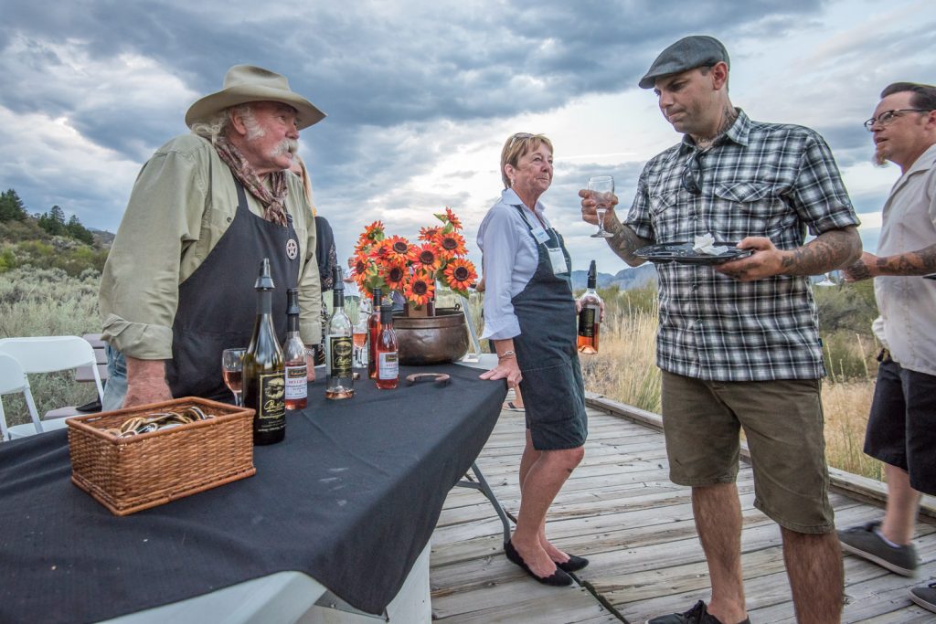 Bruce Fuller (left) of Rustico Farm and Cellars chats with guests as they sample wine on the boardwalk at the Osoyoos Desert Centre during Romancing the Desert. (Richard McGuire photo)
